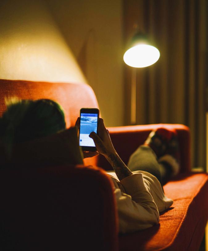 A woman on a sofa with a phone