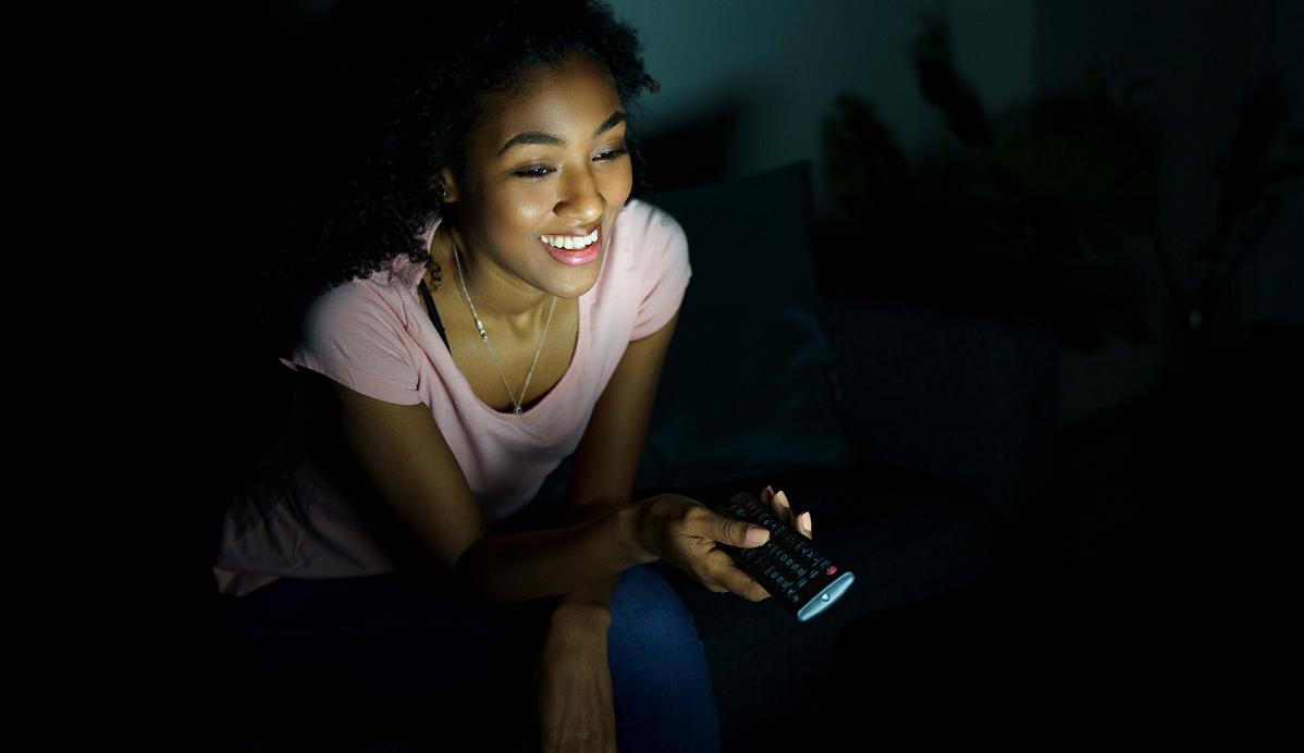 A woman with a TV remote control